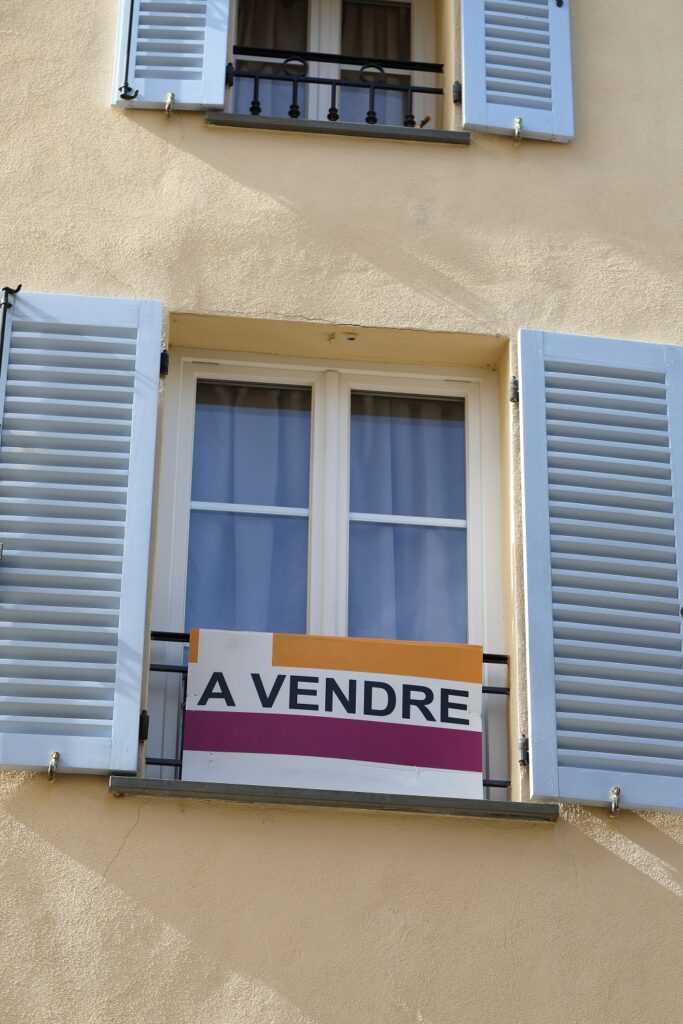 Panneau "à vendre" dans la fenêtre d'un appartement.